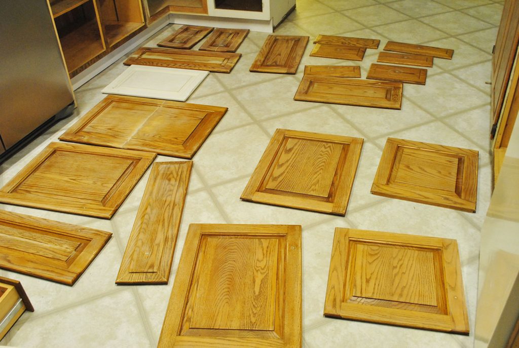 Cabinet Doors Spread Out On Kitchen Floor For Painting