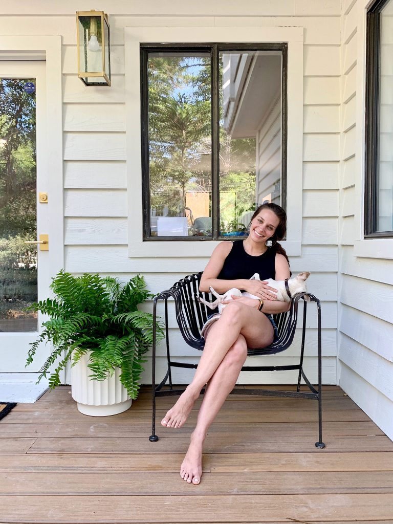 Sherry holding Burger on front porch chair