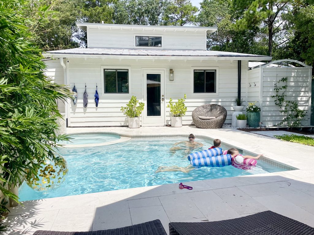 John and kids swimming in backyard pool