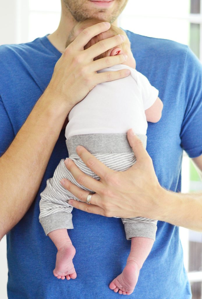 Father Holding Newborn Baby Boy On Chest