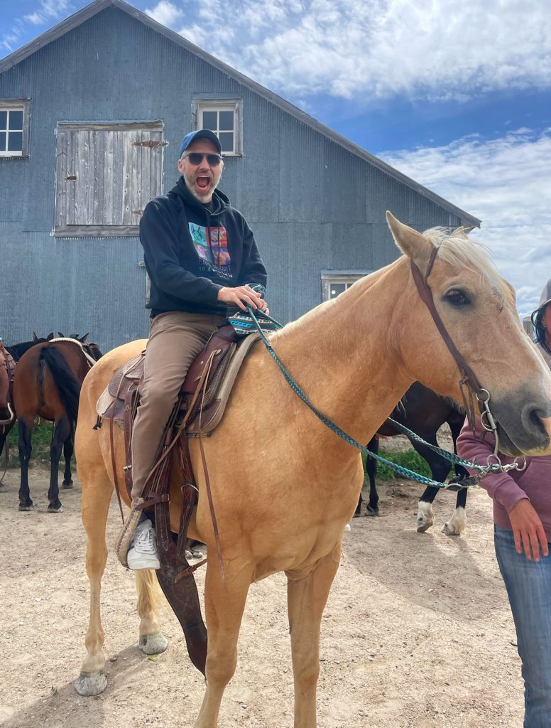 John Riding Horse In South Dakota In Front of Barn