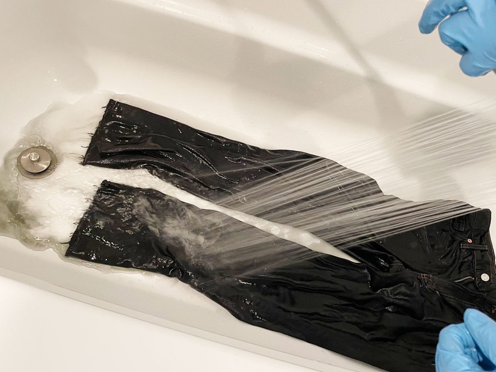 Rinsing Excess Black Dye from Jeans In Bathtub