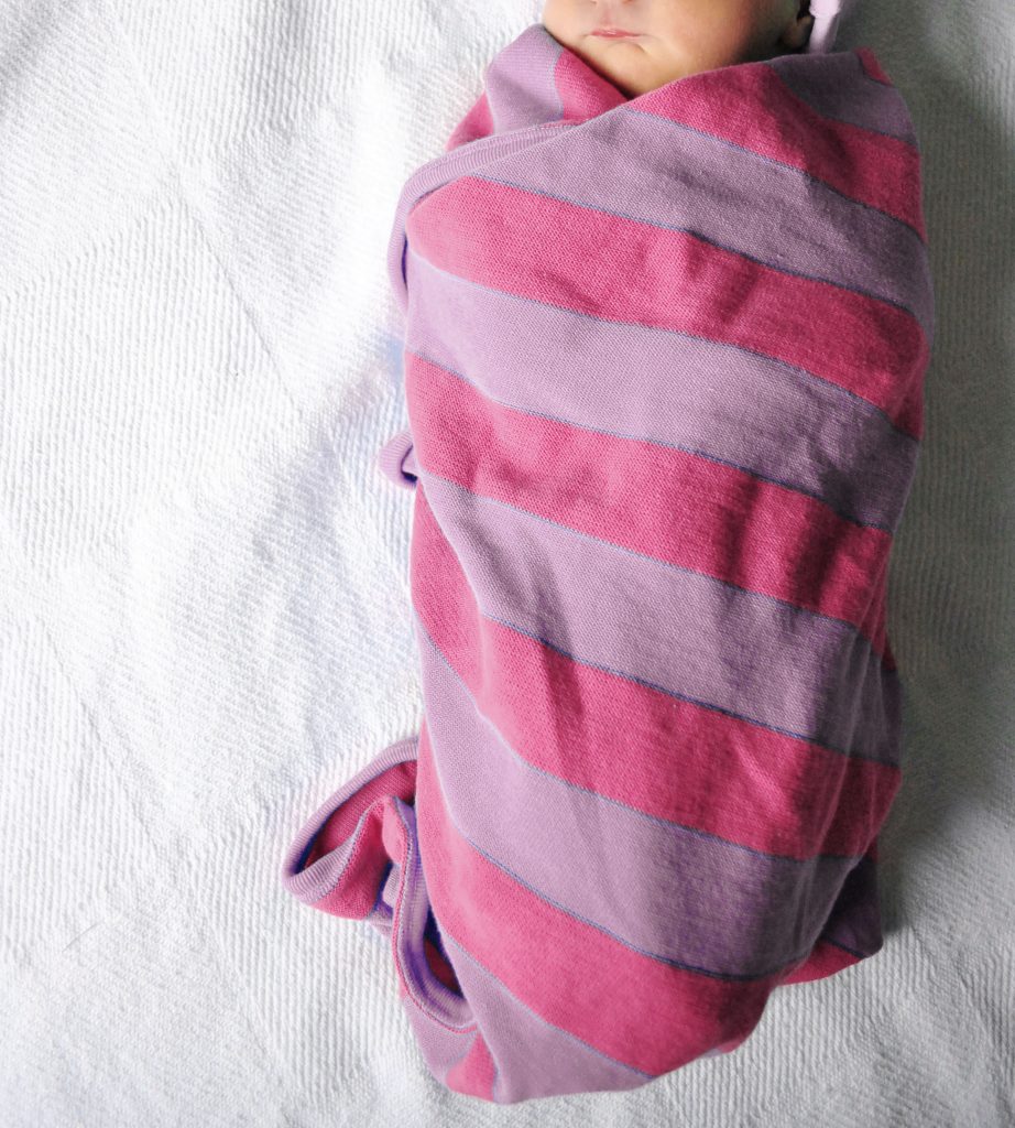 Newborn Baby Girl Swaddled In Pink Purple Striped Blanket