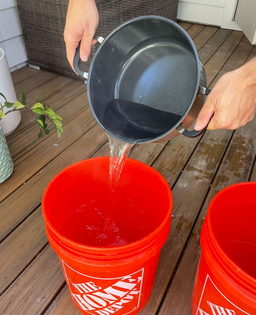 Pouring Boiling Water Into Bucket For Fabric Dye