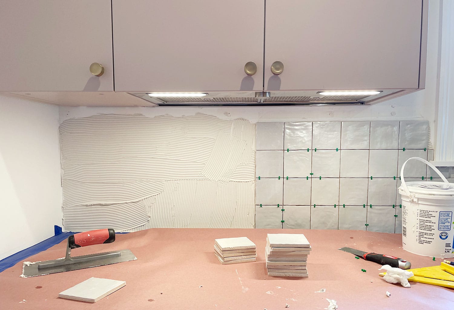 tiling under the sink of a kitchen cabnet